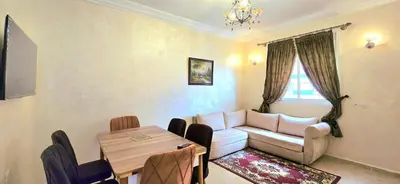 a living room with a couch and a table at Nice apart well located 2 Rooms -Only Family in Marrakech