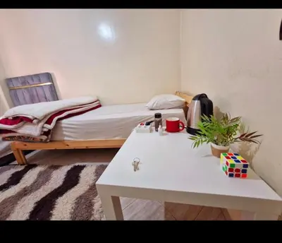 a small room with a bed and a table with a table at cozy appartement in Marrakech