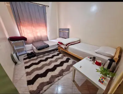 a small room with a bed and a table at cozy appartement in Marrakech