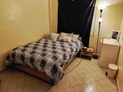 a bedroom with a bed in the corner of a room at cozy appartement in Marrakech