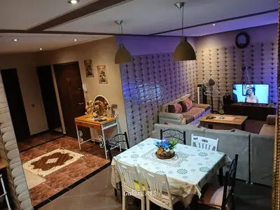 a living room with a table and a couch at Chambre unique in Marrakech
