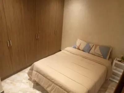 a small bedroom with a bed and wooden cabinets at Chambre unique in Marrakech