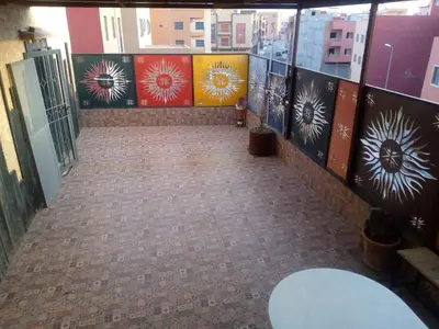 an empty hallway with paintings on the walls of a building at Chambre unique in Marrakech