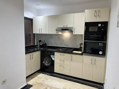 a kitchen with white cabinets and a black appliance at Elegant Suit in Guéliz in Marrakech