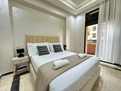 a bedroom with a large bed and a window at Elegant Suit in Guéliz in Marrakech