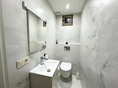 a white bathroom with a toilet and a sink at Elegant Suit in Guéliz in Marrakech
