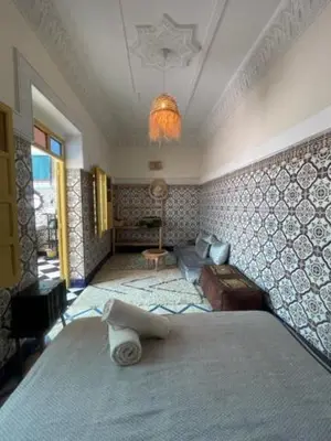 a bedroom with a bed and a living room at Khamsa in Marrakech