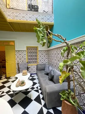 a living room with a couch and a table at Khamsa in Marrakech
