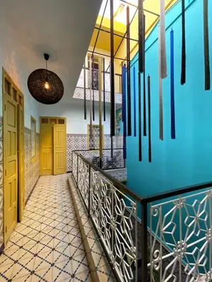 a hallway of a house with a blue wall at Khamsa in Marrakech