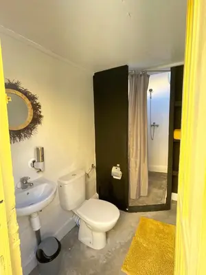 a bathroom with a white toilet and a sink at Khamsa in Marrakech