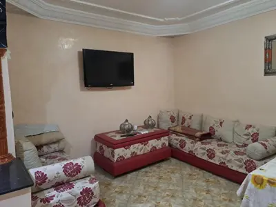 a living room with couches and a flat screen tv at Nour's PLACE in Marrakech