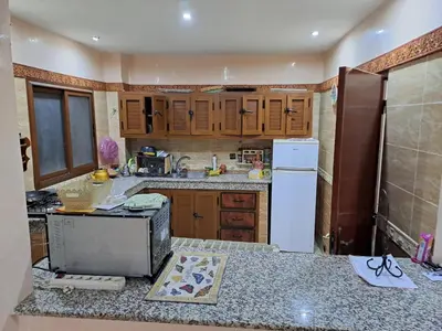 a kitchen with wooden cabinets and a counter top at Nour's PLACE in Marrakech