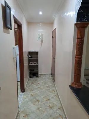 a hallway with a room with a refrigerator and a door at Nour's PLACE in Marrakech