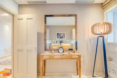 a room with a mirror and a table with a lamp at Stylish 2BR With Balcony & Designer Touches in Gueliz in Marrakech
