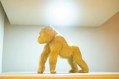 a wooden toy monkey sitting on a shelf at Stylish 2BR With Balcony & Designer Touches in Gueliz in Marrakech