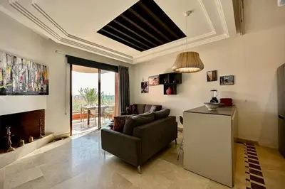 a living room with a couch and a fireplace at Sunny apartment with rooftop Water Park included in Dar Caïd Layadi