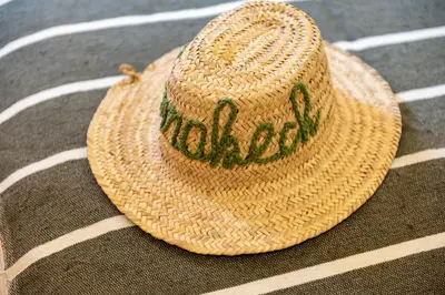 a straw hat sitting on top of a table at Marrakech Oasis, Central and Modern in Marrakech