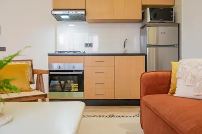 a kitchen with a stove and a couch in a room at Marrakech Oasis, Central and Modern in Marrakech
