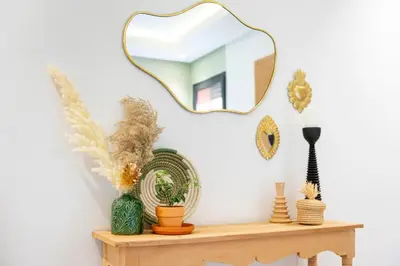 a mirror on top of a shelf with vases at Marrakech Oasis, Central and Modern in Marrakech