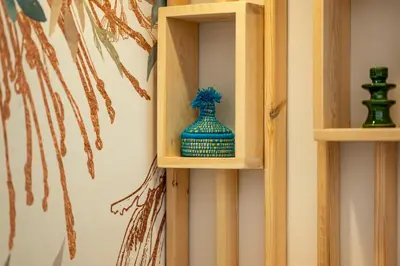 a blue vase sitting on a wooden shelf at Marrakech Oasis, Central and Modern in Marrakech