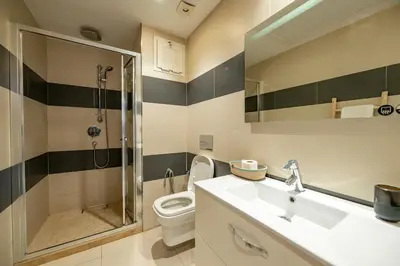 a bathroom with a shower and a toilet and a sink at Marrakech Oasis, Central and Modern in Marrakech