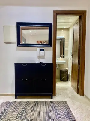 a bathroom with a black dresser and a mirror at Very comfortable apartment in a perfect location in Marrakech