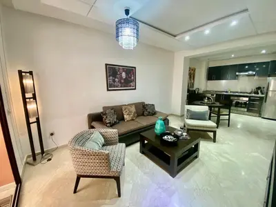 a living room with a couch and chairs and a table at Very comfortable apartment in a perfect location in Marrakech