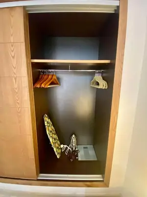 a shelf in a cabinet with some baseball equipment at Very comfortable apartment in a perfect location in Marrakech