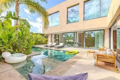 a house with a swimming pool in front of it at Villa marrakech in Marrakech