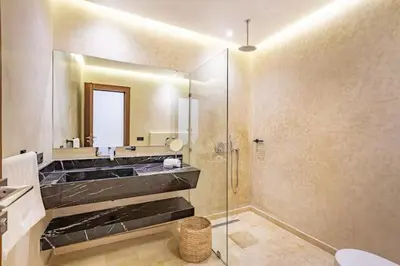 a bathroom with a shower and a sink and a mirror at Villa marrakech in Marrakech