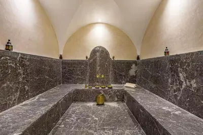 a large room with a stone wall and aasteryasteryasteryasteryasteryasteryastery at Villa marrakech in Marrakech