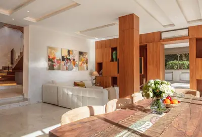 a dining room with a table and a living room at Villa Dar Saliha in Ala el Ma