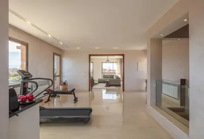 a large room with a gym with a treadmill at Villa Dar Saliha in Ala el Ma