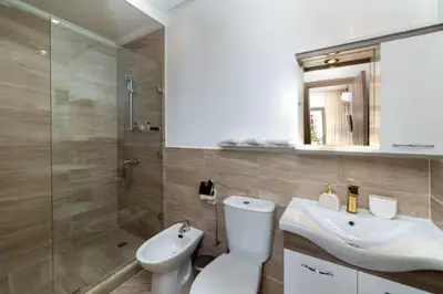 a bathroom with a toilet and a sink and a shower at jnane awrad du 18 novembre in Marrakech