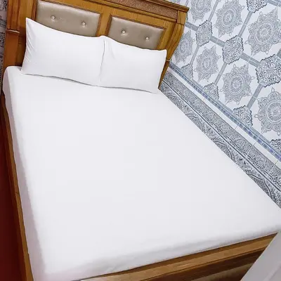 a bed with white sheets and pillows at DAR Souaad Bab Doukkala in Marrakech