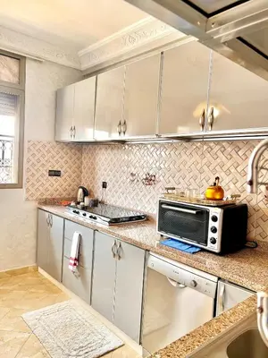 a kitchen with white cabinets and a microwave at Marrakech in Marrakech