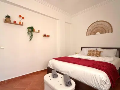 a bedroom with a bed with a red blanket at Le Cosy Nejmaa - Piscine - 4 Prs - Marrakech in Marrakech