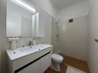 a white bathroom with a sink and a toilet at Le Cosy Nejmaa - Piscine - 4 Prs - Marrakech in Marrakech