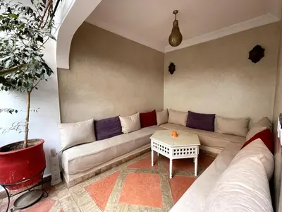 a living room with a couch and a table at Charming private riad with pool in Marrakech