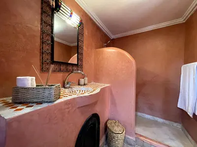 a bathroom with a sink and a mirror at Charming private riad with pool in Marrakech