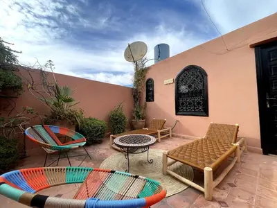 a patio with chairs and a table and chairs at Charming private riad with pool in Marrakech