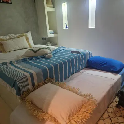 two beds sitting next to each other in a room at Riad L'EncensOriental & Spa in Marrakech