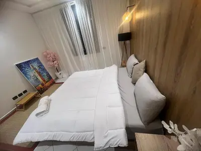 a large white bed in a hotel room at Cozy appartement au centre de marrakech in Marrakech