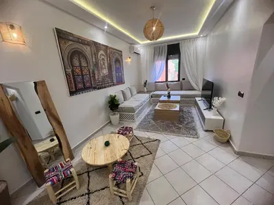a living room with a couch and a table at Cozy appartement au centre de marrakech in Marrakech