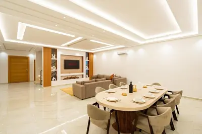 a large dining room with a table and chairs at Petit Palm in El Rhechat