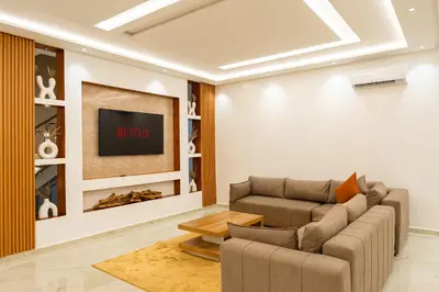 a living room with a couch and a tv at Petit Palm in El Rhechat