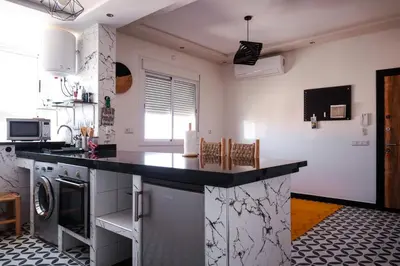 a kitchen with a black counter top in a room at Marjane Allal Fassi 2 chambres Bedrooms 2 Bathrooms Wi-Fi fibre climatisation in Marrakech