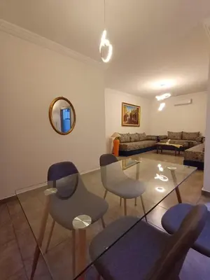 a living room with chairs and a table and a couch at Cosy 2-bedroom apt in Ourika Route in Marrakech