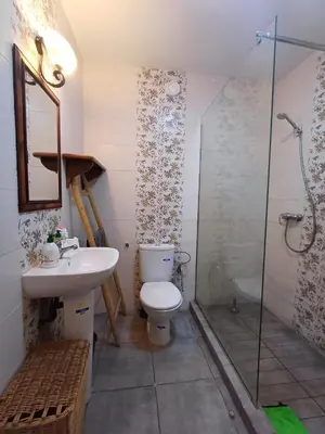 a bathroom with a toilet and a sink and a shower at Cosy 2-bedroom apt in Ourika Route in Marrakech