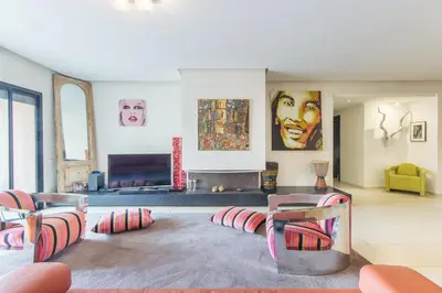 a living room with some chairs and a couch at Apartment with Private Rooftop & Jaccuzzi in Marrakech